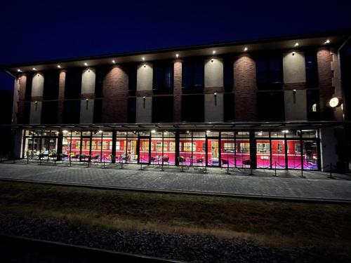 a building with pink lights in the windows at night at Ferienbahnhof Reichenbach in Dahn