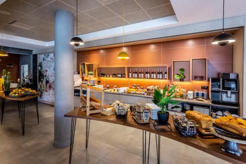 a bakery with a buffet of food on a counter at Novotel Bourges in Bourges