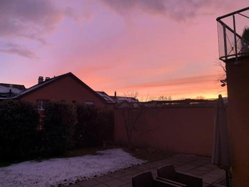 a sunset in a yard with snow on the ground at Spacious Apartment in luxurious Villa-Geneva in Geneva
