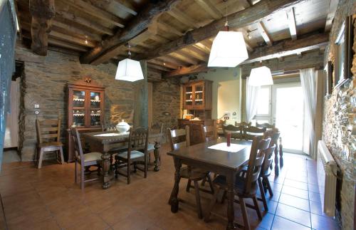 a dining room with wooden tables and chairs at VILA PEREGRINA in Arzúa