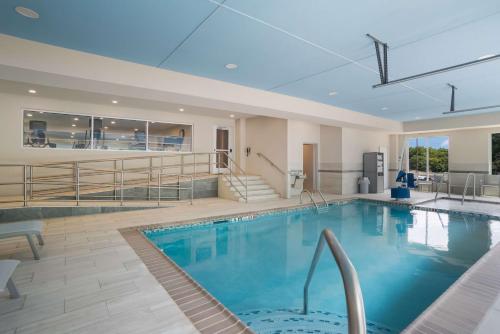 a large swimming pool in a building with a swimming pool at SureStay Plus Hotel by Best Western Elizabethtown Hershey in Elizabethtown