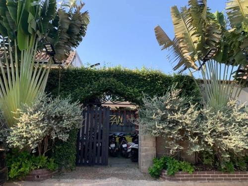 an entrance to a garage with plants and a gate at Zan HomeStay in Buon Ma Thuot
