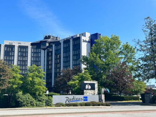 a building with a rolex sign in front of it at Radisson Blu Vancouver Airport Hotel & Marina in Richmond