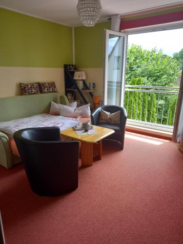 a bedroom with a bed and a table and chairs at Hübsches Zimmer nahe BER in Berlin