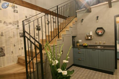 a bathroom with a staircase and a sink at Gold 68 in Kefar Barukh