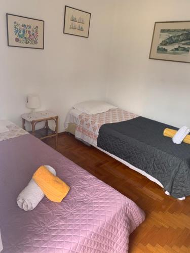 a bedroom with two beds and a purple blanket at SEAVIEW KAVALA PORT in Kavala