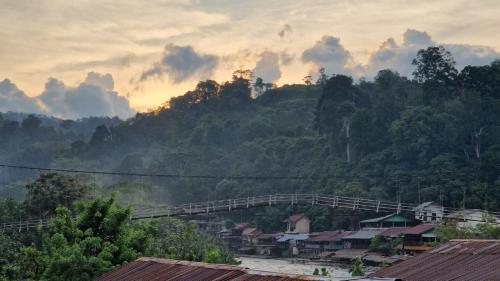 a view of a mountain with a bridge over a town at Enter Point in Bukit Lawang