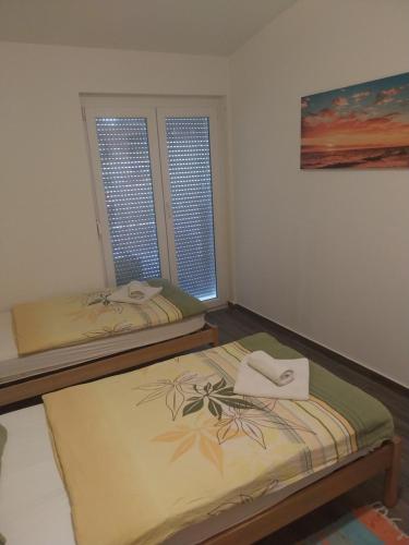Postel nebo postele na pokoji v ubytování Apartments Leon