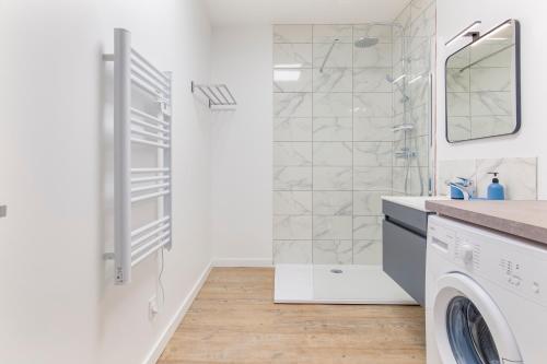 a white bathroom with a shower and a washing machine at Gambetta 302 CahorsCityStay in Cahors
