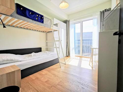 a bedroom with two bunk beds and a desk at Scandian Apartments - City Hub Tallinn in Tallinn