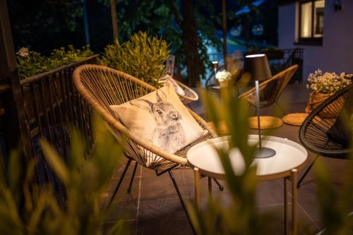 a wicker chair with a cat pillow on it at Engel 16 in Gutach