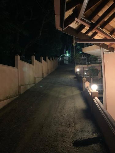 an empty street at night with lights on it at Paramount Hotel Pussellawa in Pussellawa