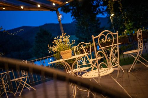 a group of chairs and tables on a balcony at night at Engel 16 in Gutach