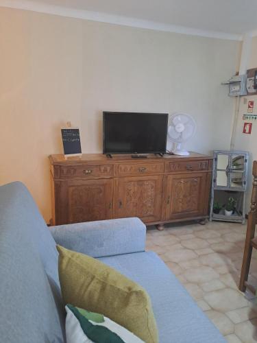 a living room with a couch and a flat screen tv at Casa Terreiro Da Lapa in Quintela