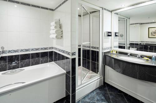 a bathroom with a tub and a sink and a shower at Delta Hotels by Marriott Durham Royal County in Durham