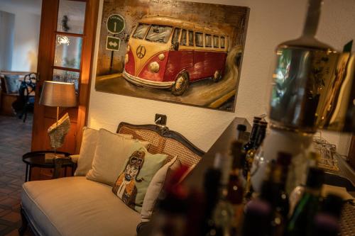 a living room with a painting of a bus on the wall at Engel 16 in Gutach
