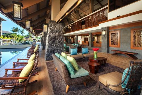 a lobby of a resort with chairs and a pool at Sheraton Kauai Resort Villas in Koloa