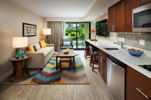 a kitchen and living room with a couch and a table at Sheraton Kauai Resort Villas in Koloa
