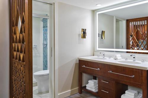 a bathroom with a sink and a toilet and a mirror at Sheraton Kauai Resort Villas in Koloa