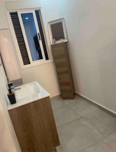 a bathroom with a sink and a window at villa aya in Saïdia