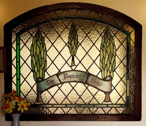a stained glass window with the words one fluorescence heals at The Poplars Moulton in Moulton