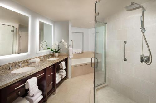 a bathroom with two sinks and a shower at The Westin Mission Hills Resort Villas, Palm Springs in Rancho Mirage
