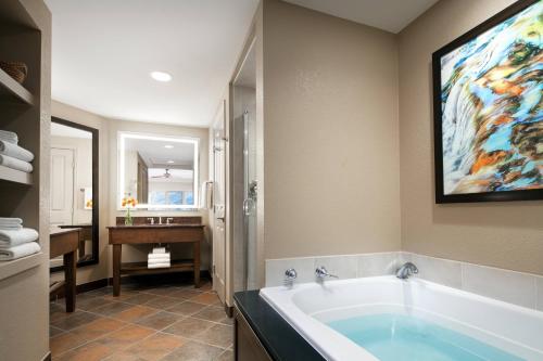 a bathroom with a tub with a painting on the wall at Sheraton Lakeside Terrace Villas at Mountain Vista, Avon, Vail Valley in Avon