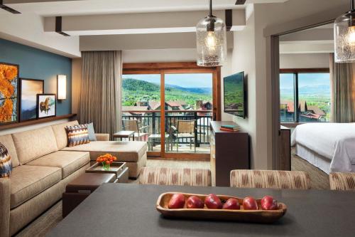 a hotel room with a bed and a living room at Sheraton Steamboat Resort Villas in Steamboat Springs