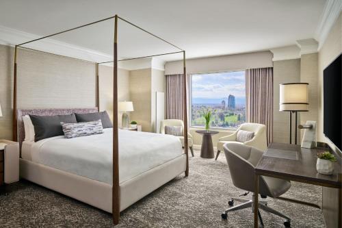 a hotel room with a bed and a desk at Hotel Clio, a Luxury Collection Hotel, Denver Cherry Creek in Denver