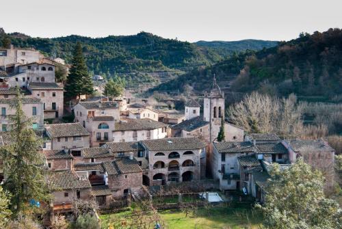 a village in the mountains with a church at APARTAMENTS PUIG GILI in Mura