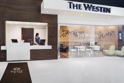 a woman is sitting at a counter in a store at The Westin St. John Resort Villas in Saint John