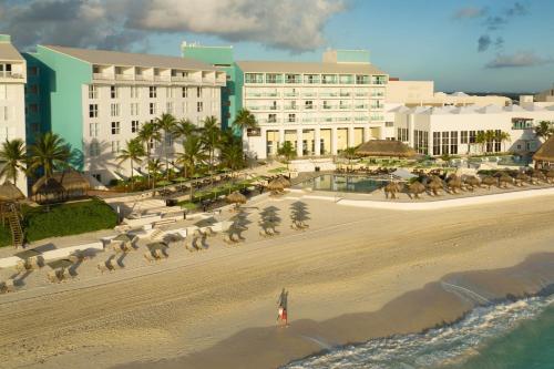 a view of a beach with buildings and birds on it at The Westin Resort & Spa Cancun in Cancún