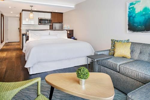 a hotel room with a bed and a couch at The Westin St. John Resort Villas in Saint John