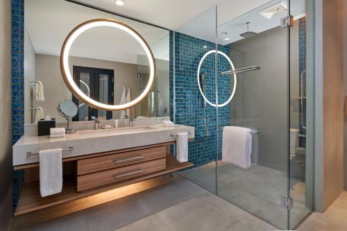 a bathroom with a sink and a mirror at Marriott's Bali Nusa Dua Terrace in Nusa Dua