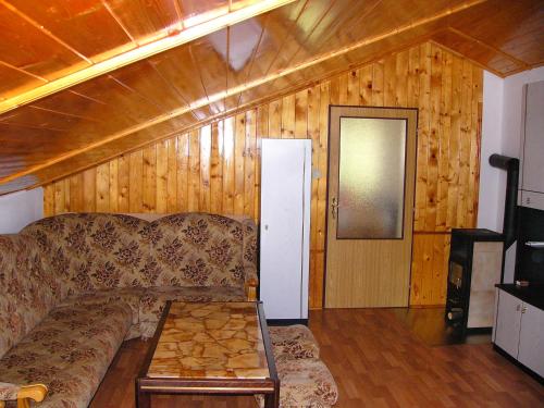 a living room with a couch and a wooden wall at Apartmán Jeseník Česká Ves in Česká Ves