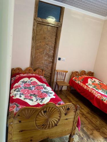 a bedroom with two beds and a window at Jachvliani Guest House in Mestia