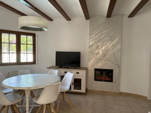 a dining room with a table and a fireplace at La Duna de Denia in Denia