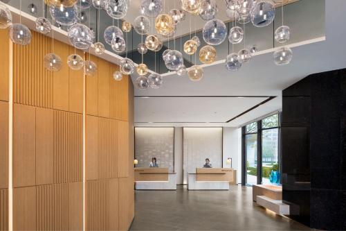 a lobby with many glass balls hanging from the ceiling at Fairfield by Marriott Xi'an Chanba in Xi'an