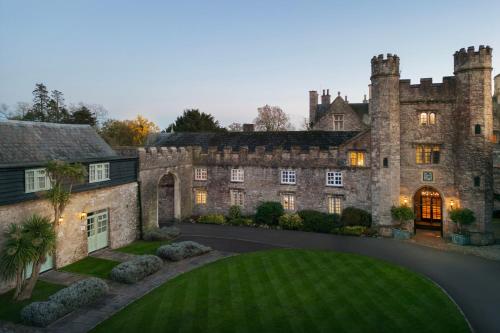 an old castle with a lawn in front of it at Delta Hotels by Marriott St Pierre Country Club in Chepstow