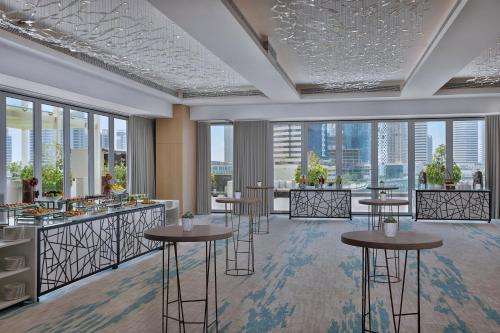 a rendering of a restaurant with tables and windows at The St. Regis Downtown Dubai in Dubai