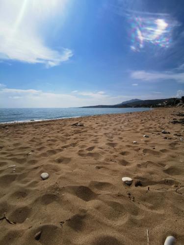 a beach with rocks in the sand and the ocean at Cala San Giorgio Residence in Sciacca
