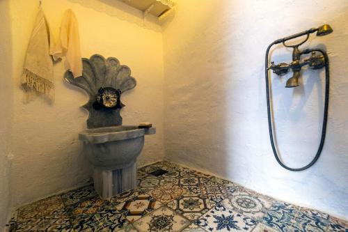 a bathroom with a toilet with a head on the wall at Authentic Bodrum House in Bodrum City
