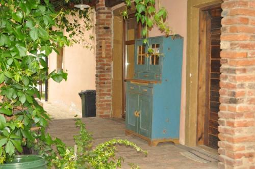 an old blue cabinet sitting outside of a building at Vintage cozy village house in Spišská Nová Ves