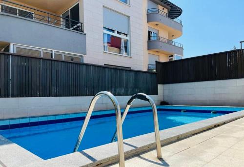 a swimming pool with metal rails next to a building at Apartment Matea in Pula