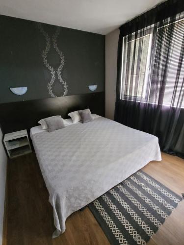 Ένα ή περισσότερα κρεβάτια σε δωμάτιο στο Guest House Taligarov