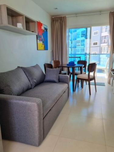 a living room with a couch and a table at Grandblue 311 in Mae Pim