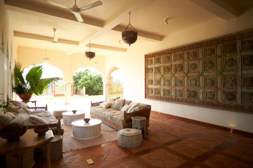 a living room with a couch and chairs and a table at Malabar Hill in Weligama
