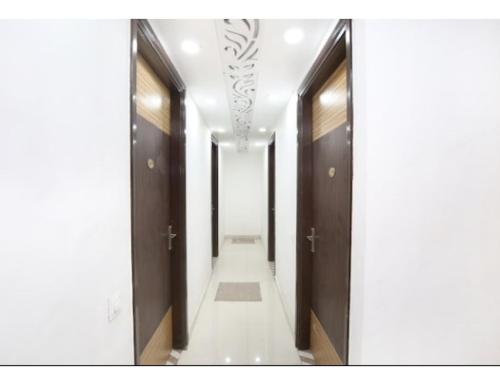 a hallway with wooden doors and a long corridor at Hotel Royal, Amritsar in Amritsar