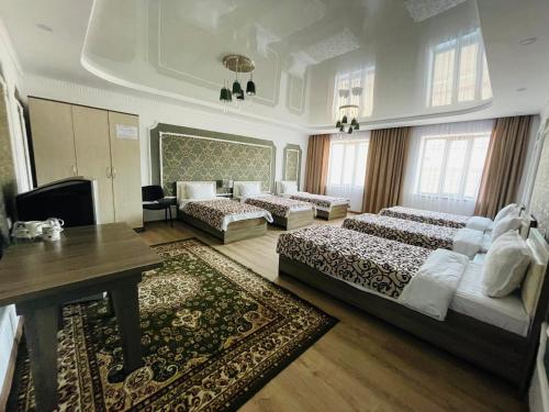 a large room with two beds and a table at Muras in Bokonbayevo