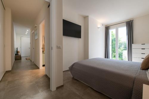 a bedroom with a bed and a large window at La casa di Guido in San Giovanni in Marignano